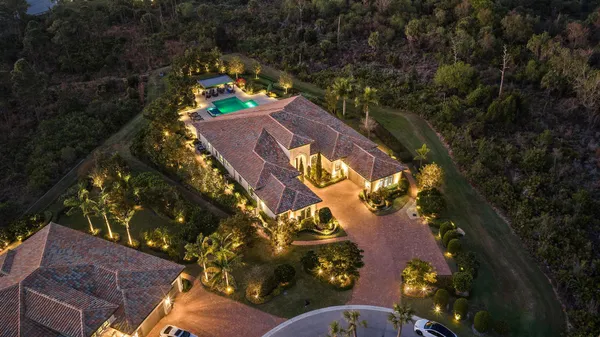 a view of a swimming pool with an outdoor seating and a yard