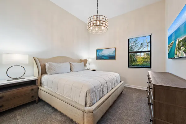 a view of a swimming pool with a yard from a lake view