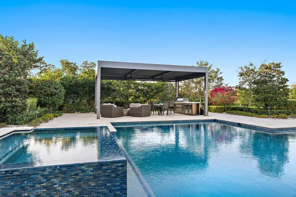 an aerial view of a house with yard and outdoor seating