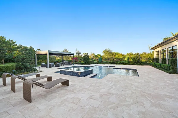 a view of a house with a yard and mountain view in back