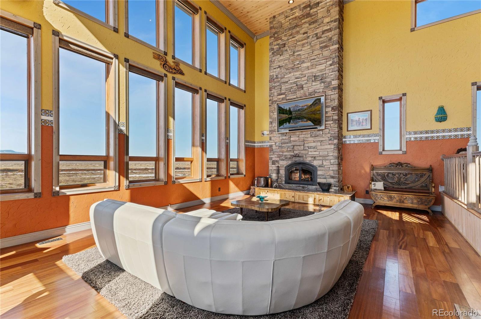 731 County Road 121 Walsenburg, CO 81089 - Photo 13 of 50 a living room with fireplace furniture and a floor to ceiling window