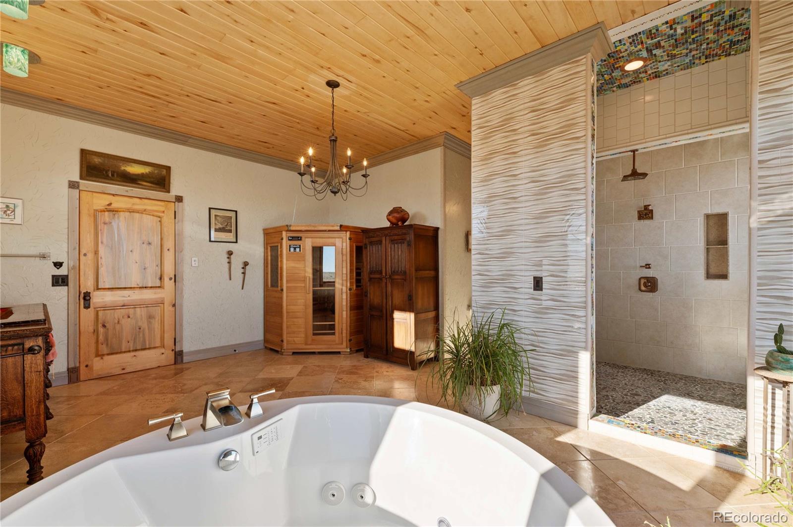 731 County Road 121 Walsenburg, CO 81089 - Photo 22 of 50 a spacious bathroom with a tub a double vanity and a mirror