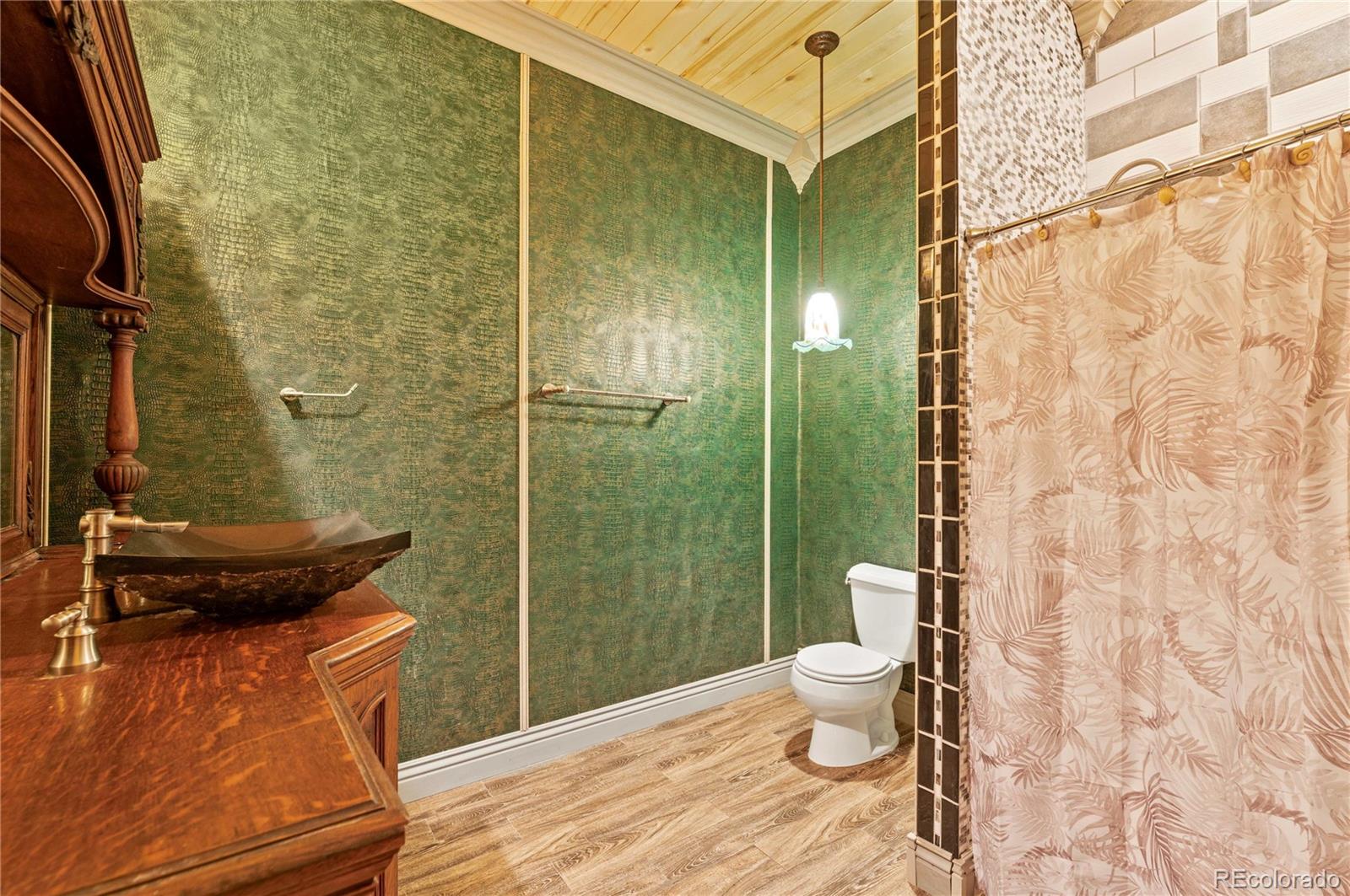 731 County Road 121 Walsenburg, CO 81089 - Photo 36 of 50 a bathroom with a granite countertop sink toilet and shower