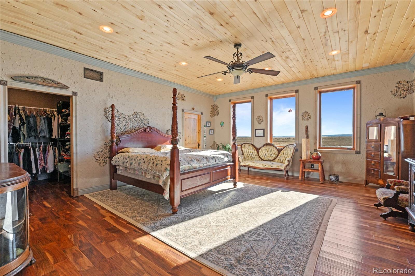731 County Road 121 Walsenburg, CO 81089 - Photo 40 of 50 a spacious bedroom with a bed a bookshelf and a large window