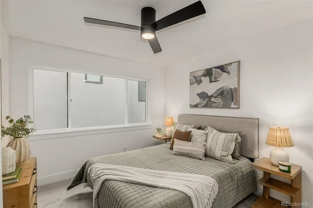 a bedroom with a bed and a painting on the wall