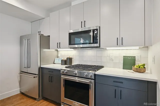 a kitchen with stainless steel appliances a refrigerator sink and stove