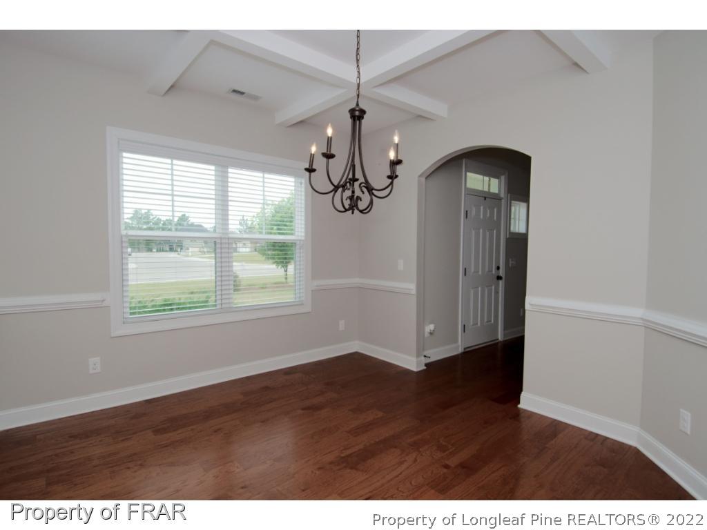 105 Caulfield Road Aberdeen, NC 28315 - Photo 11 of 36 a view of empty room with wooden floor and fan