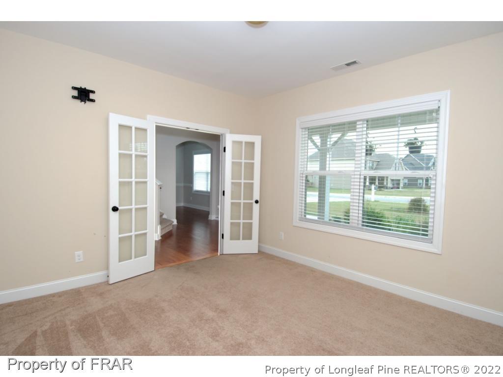 105 Caulfield Road Aberdeen, NC 28315 - Photo 12 of 36 a view of an empty room with a window