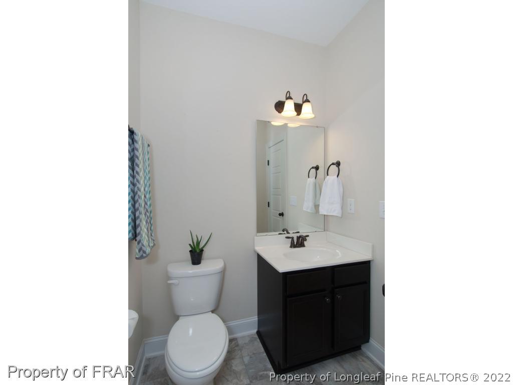 105 Caulfield Road Aberdeen, NC 28315 - Photo 15 of 36 a bathroom with a toilet sink and mirror