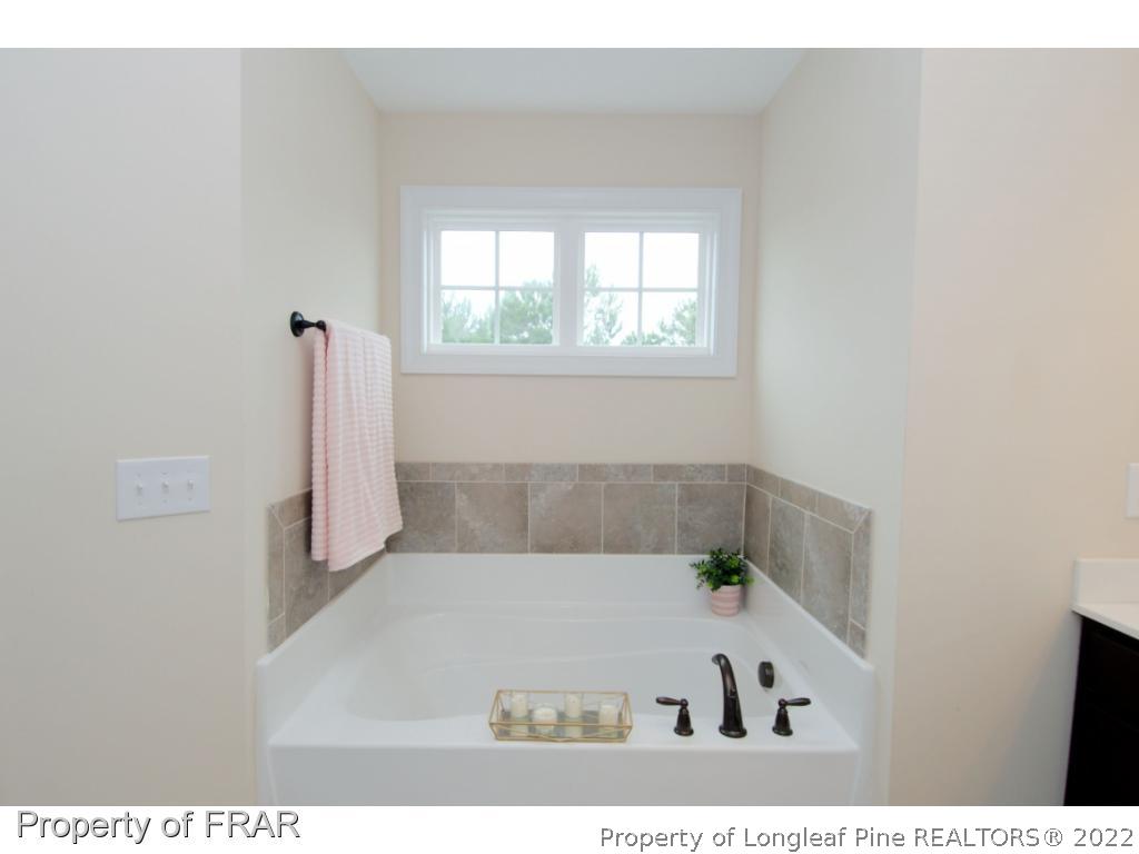 105 Caulfield Road Aberdeen, NC 28315 - Photo 21 of 36 a view of a bedroom with a bed