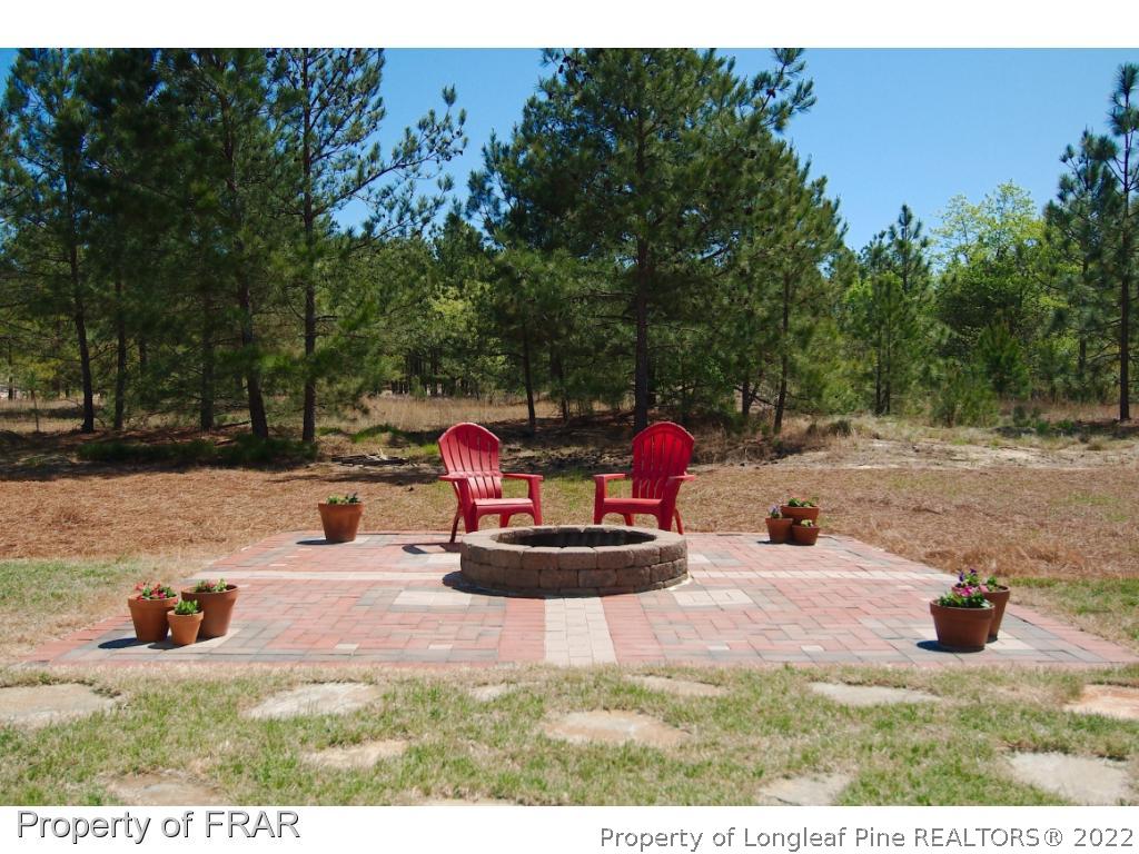 105 Caulfield Road Aberdeen, NC 28315 - Photo 33 of 36 a view of a backyard with table and chairs