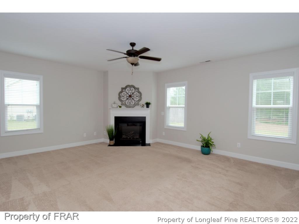 105 Caulfield Road Aberdeen, NC 28315 - Photo 10 of 36 a view of an empty room with a window and fireplace