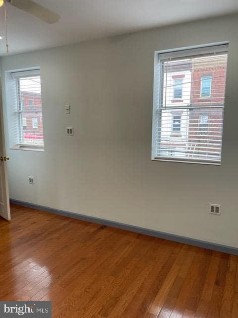 1425 Jackson Street Philadelphia, PA 19145 - Photo 5 of 9 a view of an empty room with wooden floor and a window