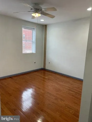 an empty room with closet and wooden floor