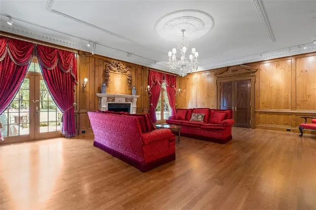 a living room with furniture and a chandelier