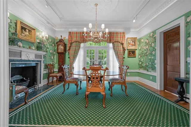 a dining room with furniture a fireplace and a chandelier