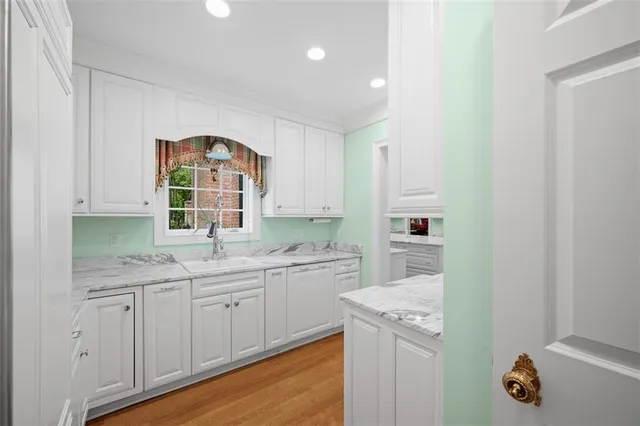 a kitchen with a sink cabinets and window