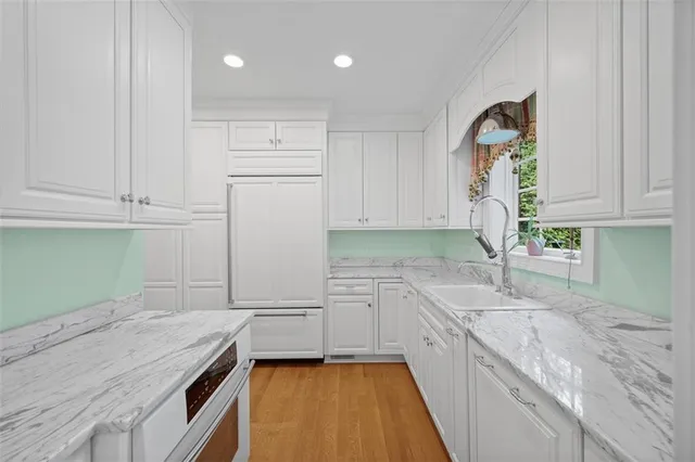a kitchen with granite countertop cabinets stainless steel appliances and a counter space