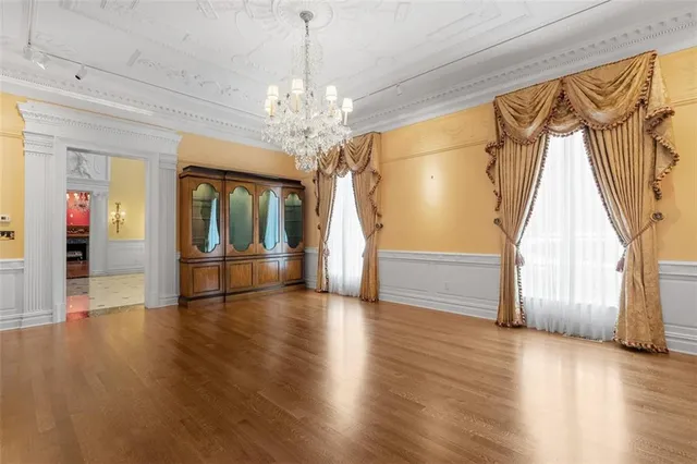 a view of a livingroom with wooden floor and stairs
