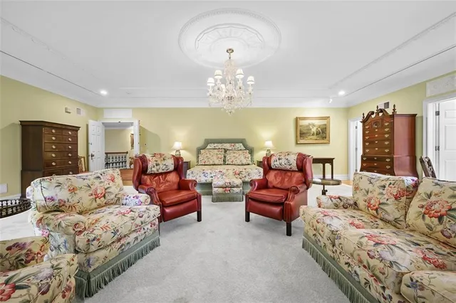 a spacious bedroom with a bed and ceiling fan