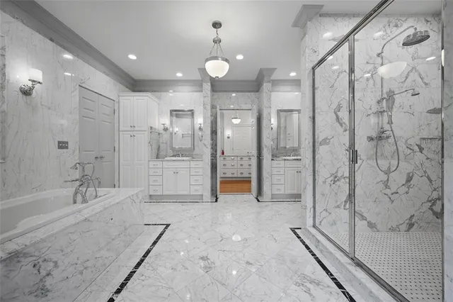 a bathroom with a glass shower door and a sink