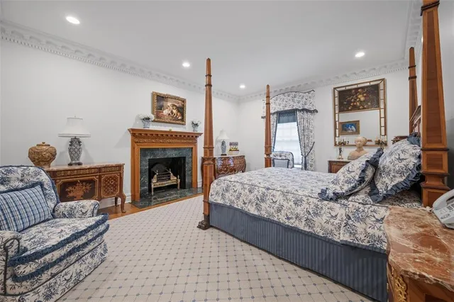 a bedroom with a large bed and a fireplace