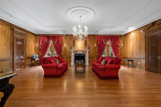 a living room with fireplace furniture and a chandelier