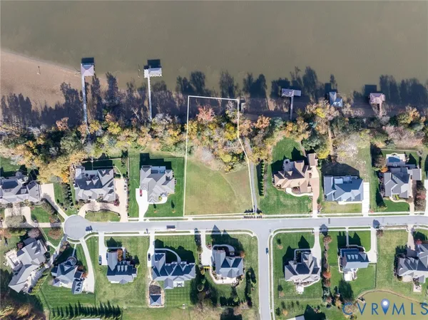 an aerial view of a house with outdoor space lake view and an ocean view