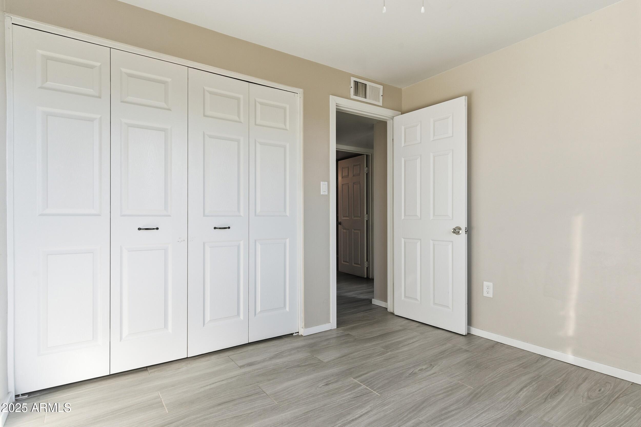 7150 West Montecito Avenue Phoenix, AZ 85033 - Photo 14 of 30 a view of an empty room and wooden floor