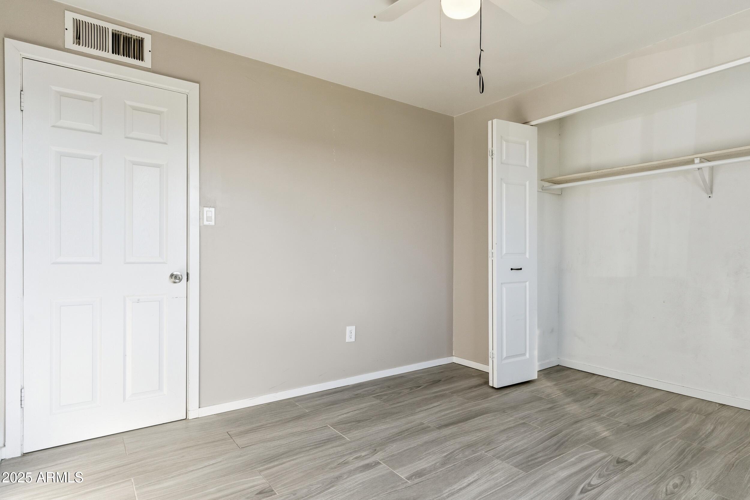7150 West Montecito Avenue Phoenix, AZ 85033 - Photo 18 of 30 a view of an empty room with wooden floor