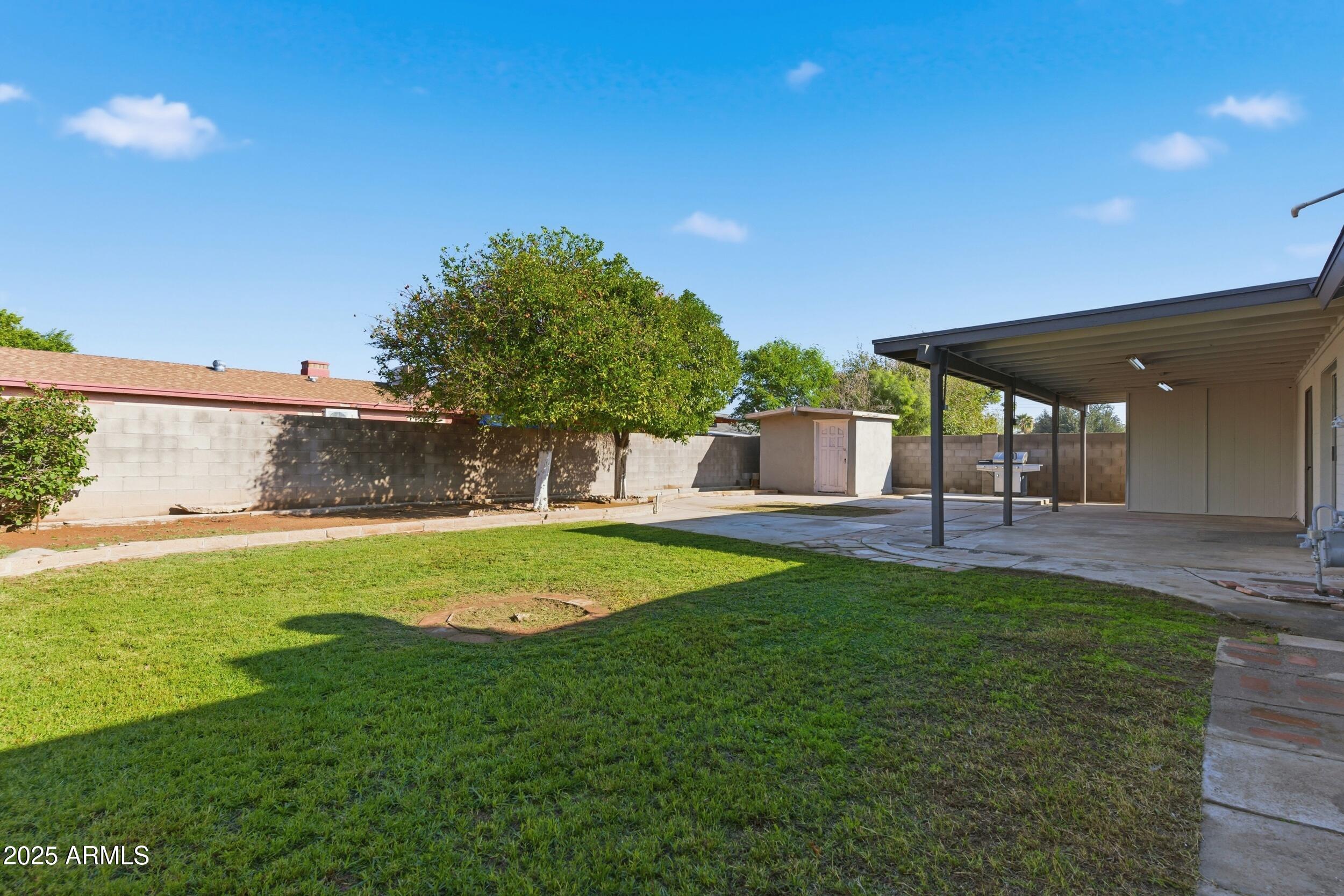 7150 West Montecito Avenue Phoenix, AZ 85033 - Photo 25 of 30 a view of a backyard with a garden and entertaining space