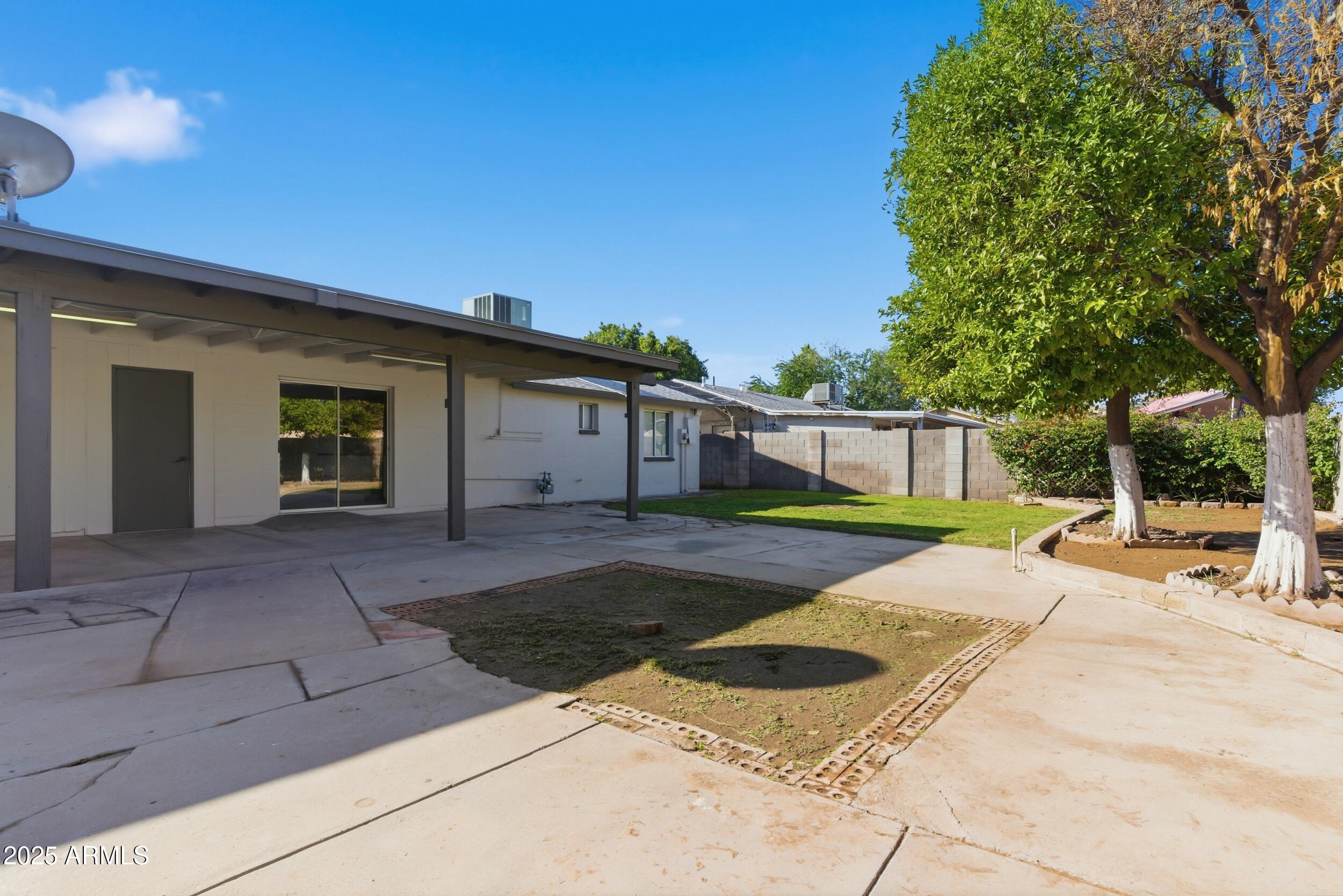 7150 West Montecito Avenue Phoenix, AZ 85033 - Photo 26 of 30 a view of a house with backyard and trees