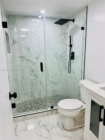 a bathroom with a toilet and a shower