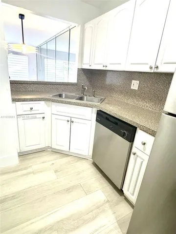 a kitchen with stainless steel appliances granite countertop a sink a stove and a microwave