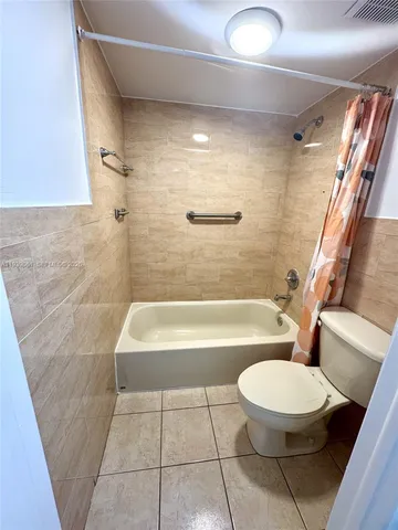 a bathroom with a bathtub and a toilet