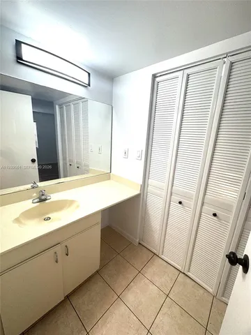a bathroom with a double vanity sink and mirror