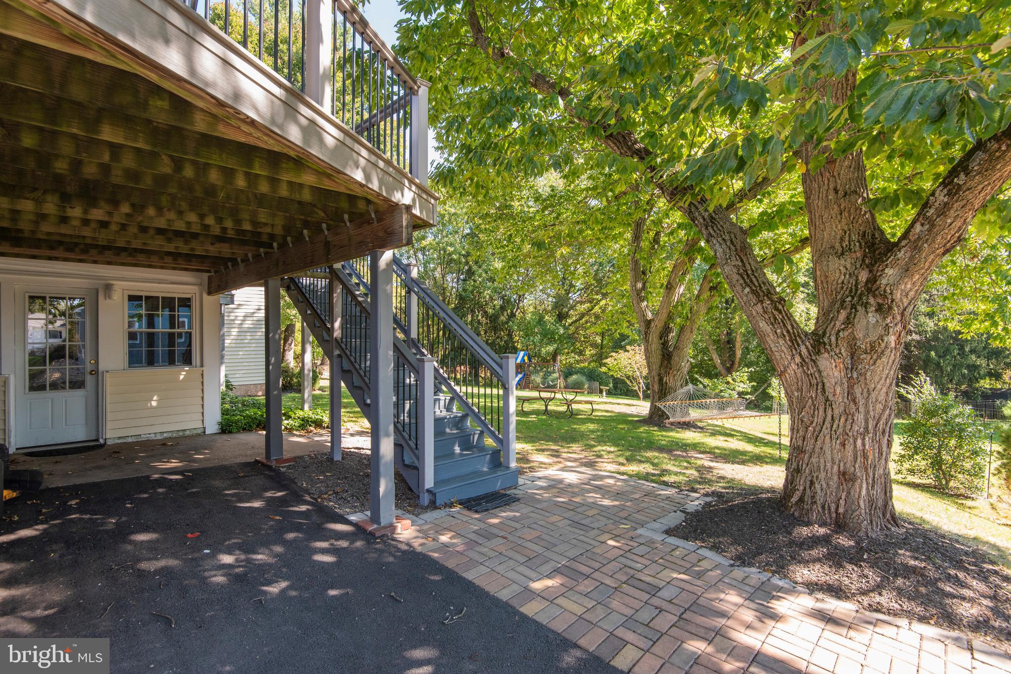 1736 Aidenn Lair Road Dresher, PA 19025 - Photo 33 of 36 Stairs from deck to paved patio at rear