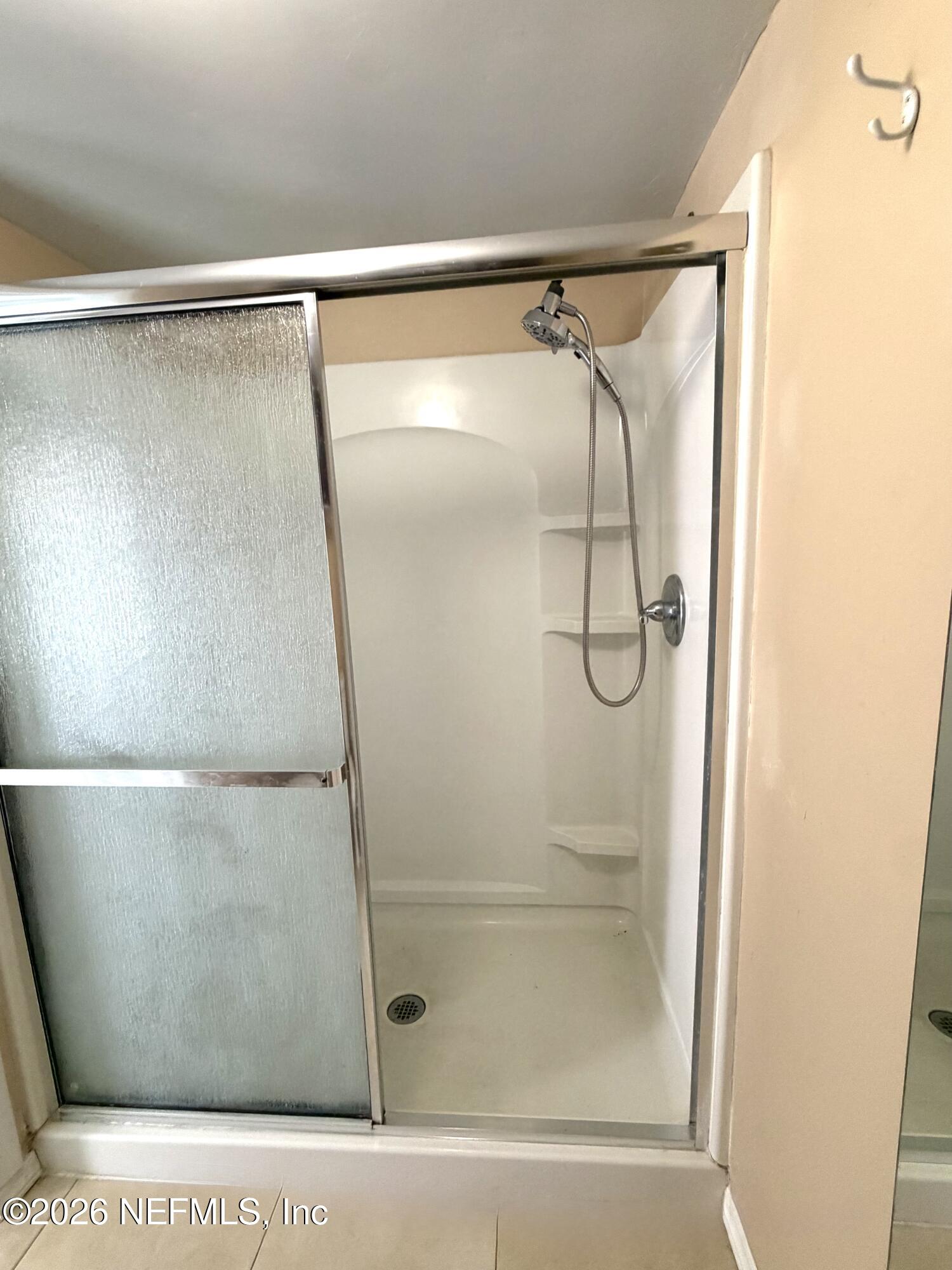 4127 Springwood Road Jacksonville, FL 32207 - Photo 60 of 63 a bathroom with a glass shower door