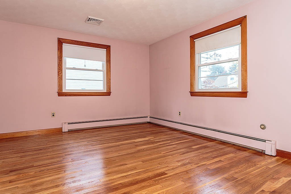 20 South Rhoda Street Tewksbury, MA 01876 - Photo 16 of 24 a view of an empty room with wooden floor and a window