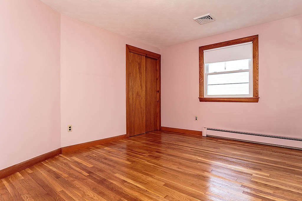 20 South Rhoda Street Tewksbury, MA 01876 - Photo 17 of 24 an empty room with wooden floor and windows