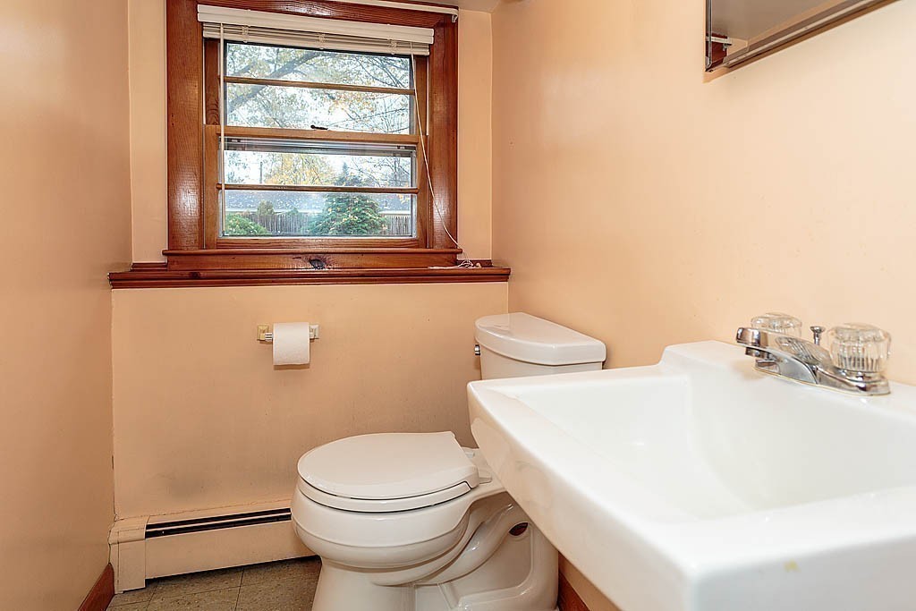 20 South Rhoda Street Tewksbury, MA 01876 - Photo 23 of 24 a white toilet sitting next to a bathroom sink