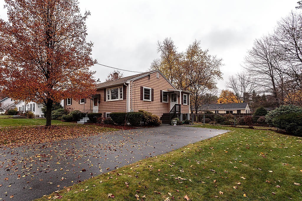 20 South Rhoda Street Tewksbury, MA 01876 - Photo 3 of 24 a view of a yard with a house and a large tree