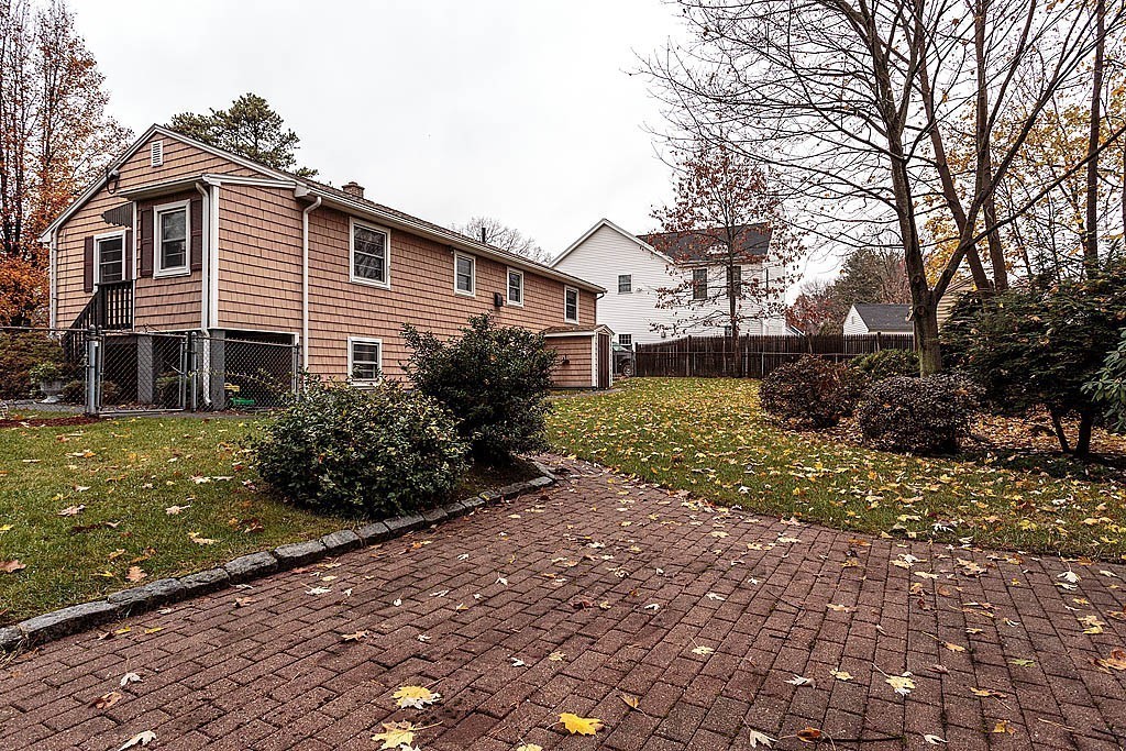 20 South Rhoda Street Tewksbury, MA 01876 - Photo 5 of 24 a front view of a house with a yard and shrubs