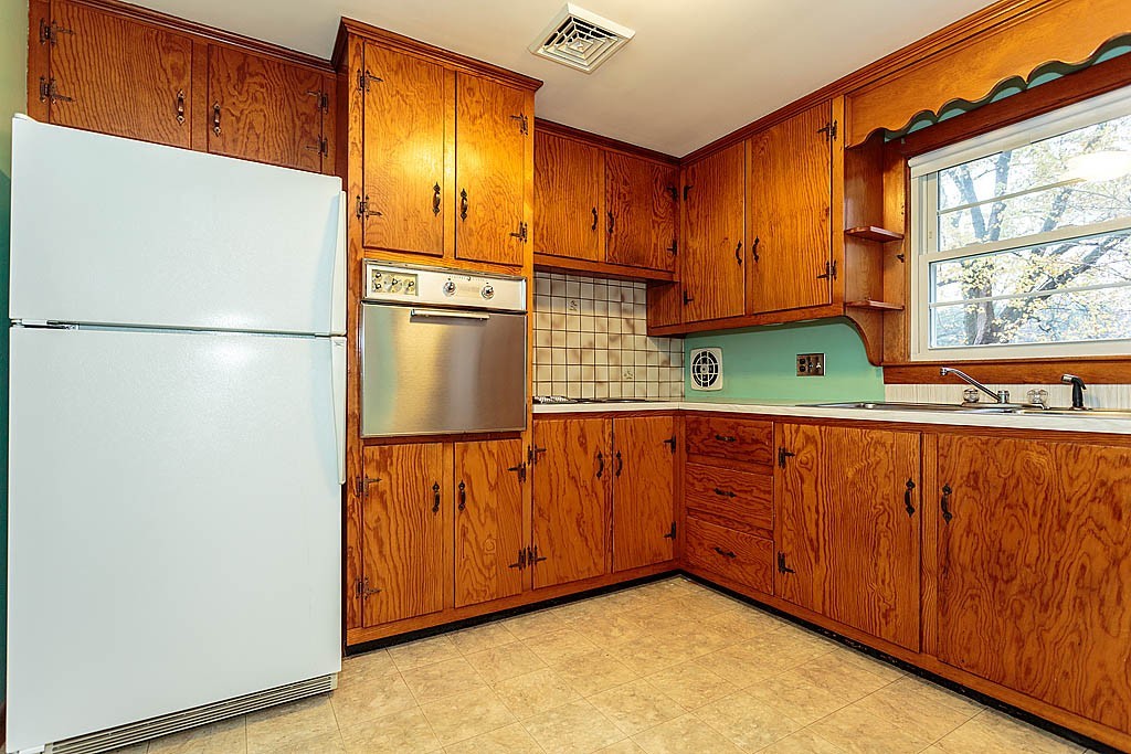 20 South Rhoda Street Tewksbury, MA 01876 - Photo 8 of 24 a kitchen with cabinets and a refrigerator