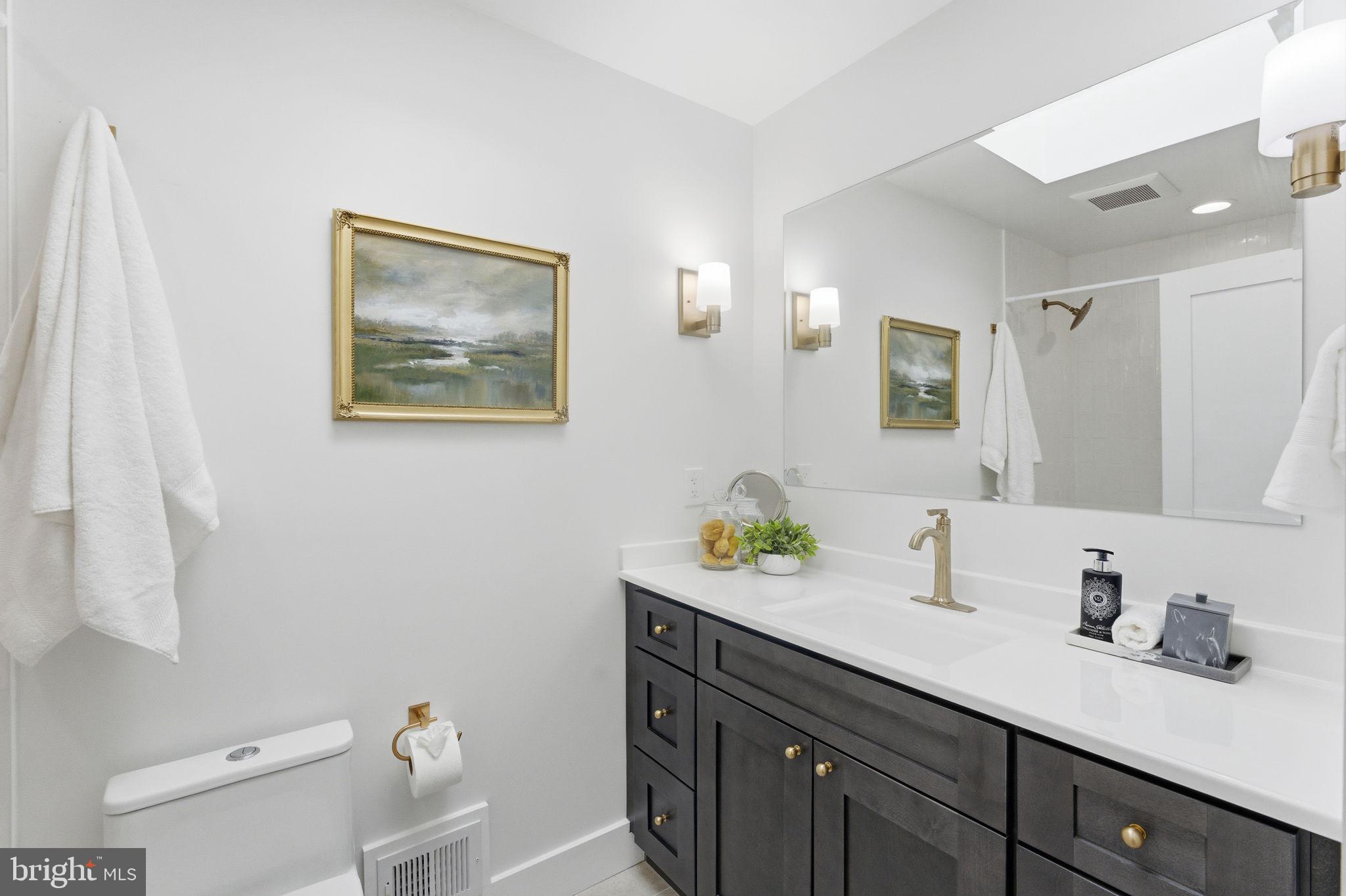 8615 Kerry Lane Springfield, VA 22152 - Photo 24 of 50 a bathroom with a granite countertop sink mirror and toilet
