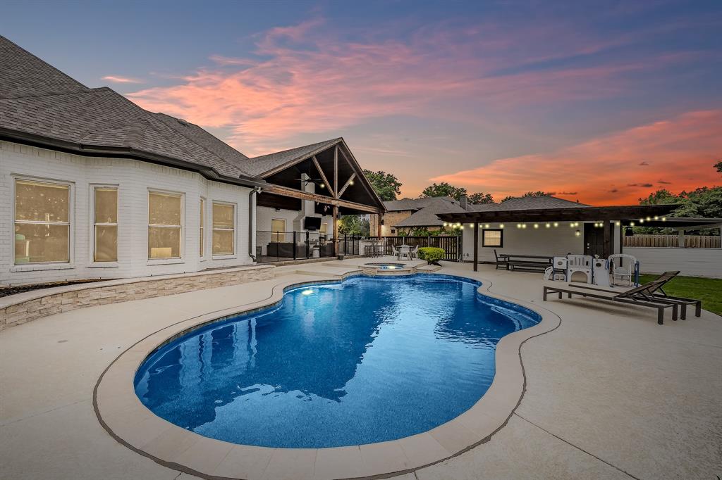 115 Pheasant Run Road Argyle, TX 76226 - Photo 5 of 40 a view of a swimming pool with a lounge chair