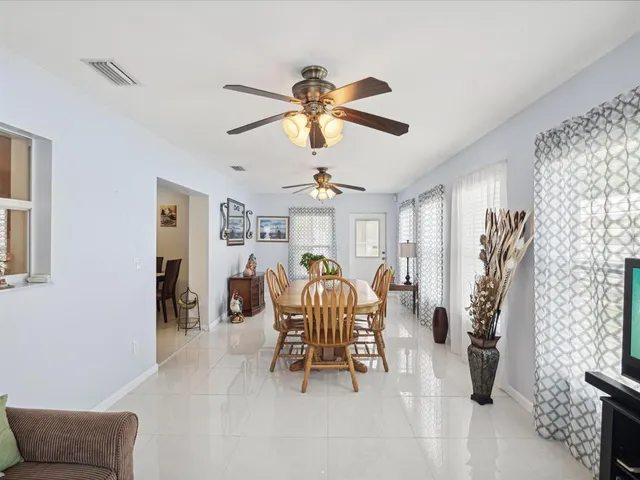 a dining room with furniture and a chandelier