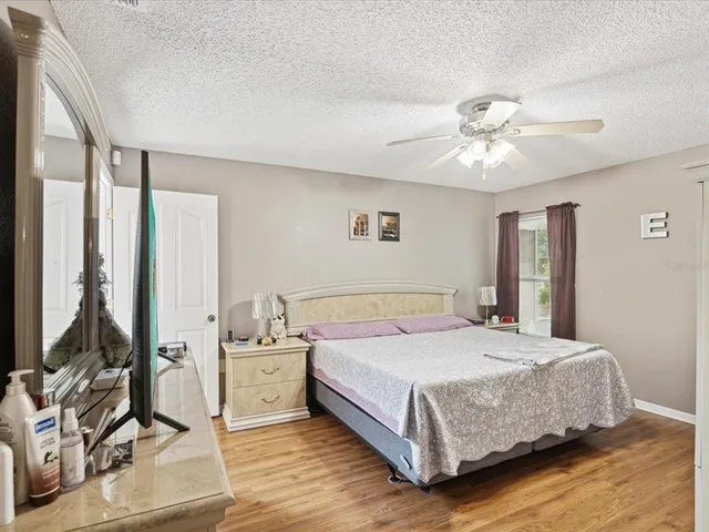 a bedroom with a bed chandelier and a window