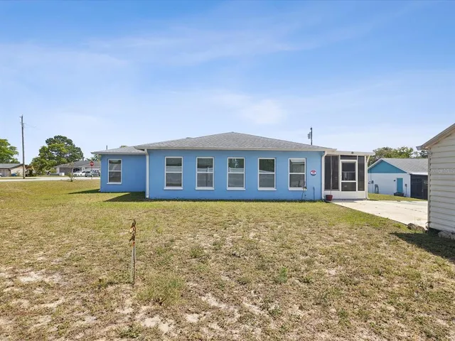 an aerial view of residential houses with outdoor space and swimming pool