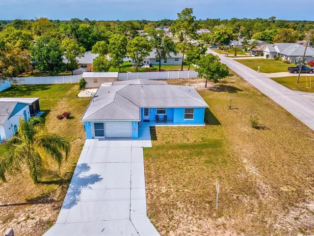 an aerial view of residential houses with outdoor space and swimming pool